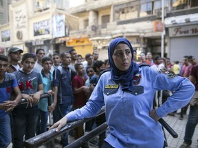 FILE - In this July 17, 2015 file photo, an Egyptian policewoman from a newly formed  force to combat sexual harassment in the streets is deployed in Cairo on the first day of Eid Al-Fitr. A video posted on Facebook Aug. 15, 2018, by an Egyptian woman who says a man stalked her at a bus stop has stirred online debate, with many -- including women -- taking the man's side. Some say he was politely flirting and the woman overreacted, while others have speculated about what she was wearing, suggesting she was the one at fault. The diverging responses point to the difficulty in combatting the rampant sexual harassment on Egypt's streets.