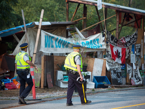 Burnaby RCMP and Burnaby officials dismantle Camp Cloud near the entrance of the Kinder Morgan Trans Mountain pipeline facility in Burnaby, B.C., on Aug. 16, 2018.