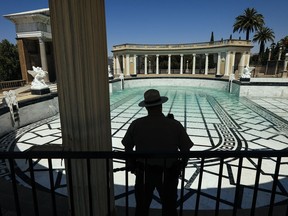 FILE - In this Tuesday, Aug. 14, 2018, file photo Dan Falat, San Luis Obispo Coast District Superintendent of California State Parks, watches as the Neptune Pool at Hearst Castle in San Simeon, Calif., is filled with water. State parks officials said Tuesday that they have begun to refill the 345,000-gallon pool, which was drained in 2014 after cracks caused it to leak up to 5,000 gallons a day. (Joe Johnston/The Tribune