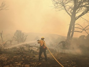 The Ranch Fire spots out ahead of the main fire in Spring Valley, Calif., burning two homes, Monday, Aug. 6, 2018, during the battle to stop the spread of the massive fire in Lake County.