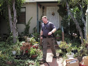 An FBI agent leaves the home of Robert Chain in the Encino section of Los Angeles on Thursday, Aug. 30, 2018. Chain who was upset about The Boston Globe's coordinated editorial response to President Donald Trump's attacks on the news media, was arrested Thursday for threatening to travel to the newspaper's offices and kill journalists, whom he called the "enemy of the people," federal prosecutors said.
