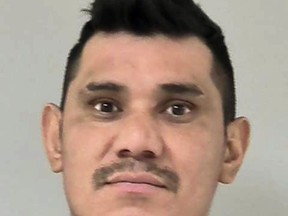 This photo provided by the Scott County Jail in Shakopee, Minn., shows Fraider Diaz-Carbajal, who was charged Monday, Aug. 20, 2018, with second-degree murder in the Aug. 12 death of Enedelia Perez Garcia in his apartment in the Minneapolis suburb of Shakopee. Federal officials say Diaz-Carbajal, accused of fatally stabbing his ex-girlfriend before slashing his own throat, entered the U.S. illegally after being deported in 2012. (Scott County Jail via AP)