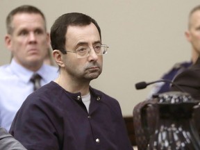 FILE - In this Jan. 24, 2018, file photo, Larry Nassar, a former doctor for USA Gymnastics and member of Michigan State's sports medicine staff, sits in court during his sentencing hearing in Lansing, Mich. Michigan State University said Thursday, Aug. 30, 2018, that the NCAA has cleared it of any rules violations in the Nassar sexual-assault scandal. Nassar pleaded guilty to assaulting girls and women while working as a campus sports doctor for Michigan State athletes and gymnasts in the region.