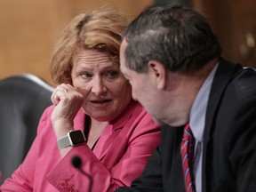 FILE - In this Aug. 21, 2018 file photo, Sen. Heidi Heitkamp, D-N.D., left, and Sen. Joe Donnelly, D-Ind., speak on Capitol Hill in Washington. Heitkamp says in a television ad that 300,000 North Dakota residents with pre-existing medical conditions couldn't get health insurance before former President Barack Obama's health care law. Heitkamp is about right on the number of North Dakotans who have such conditions, but she overstates the number who wouldn't have been able to get health insurance.