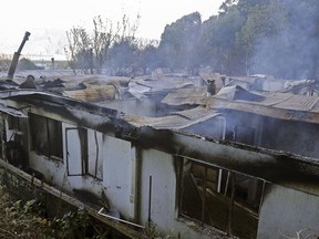 A nursing home building smolders after fire in which at least ten elderly persons died, in Chiguayante, Chile, Tuesday, Aug. 14, 2018. At least Ten elderly persons died in the voracious fire that destroyed the bedroom in which they rested, informed the governor of Bío Bio, Jorge Ulloa.