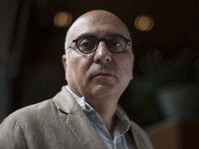 Author Rawi Hage poses in Toronto on Tuesday, August 28, 2018, as he promotes his new novel "Beirut Hellfire Society." Death is on Rawi Hage's mind. It's been that way for about four years, says the acclaimed Lebanese-Canadian author, who examines the heavy subject in his latest novel, "Beirut Hellfire Society."