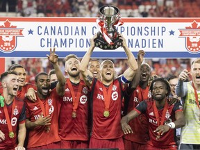 Toronto FC captain Michael Bradley lifts the Voyageurs Cup after beating Vancouver Whitecaps 5-2 to win the Canadian Championship Final, in Toronto on Wednesday, August 15, 2018.