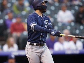 San Diego Padres' Eric Hosmer follows the flight of his two-run home run off Colorado Rockies starting pitcher Tyler Anderson in the first inning of a baseball game Tuesday, Aug. 21, 2018, in Denver.