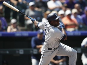San Diego Padres' Jose Pirela singles against Colorado Rockies starting pitcher Kyle Freeland in the first inning of a baseball game Thursday, Aug. 23, 2018, in Denver.