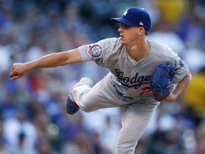Los Angeles Dodgers starting pitcher Walker Buehler works against the Colorado Rockies in the first inning of a baseball game Saturday, Aug. 11, 2018, in Denver.