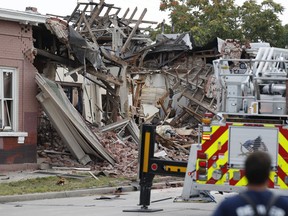 Rubble from an apparent gas explosion in a row of homes is strewn along a block on Santa Fe Boulevard Tuesday, Aug. 14, 2018, in Denver. Firefighters say 10 people have been injured, one critically, in the apparent explosion, which leveled a portion of a brick row house just south of downtown.