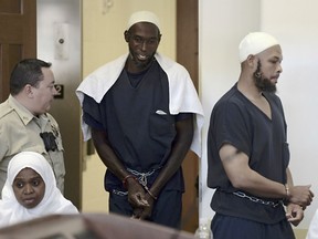 Defendants, from left, Jany Leveille, Lucas Morton, Siraj Wahhaj enter district court in Taos, N.M., for a detention hearing, Monday, Aug. 13, 2018. Several defendants have been charged with child abuse stemming from the alleged neglect of 11 children found living on a squalid compound on the outskirts of tiny Amalia, New Mexico.