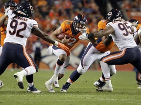 Denver Broncos quarterback Paxton Lynch (12) is sacked by Chicago Bears defensive end Roy Robertson-Harris (95) and defensive tackle John Jenkins (92) during the second half of a preseason NFL football game, Saturday, Aug. 18, 2018, in Denver.