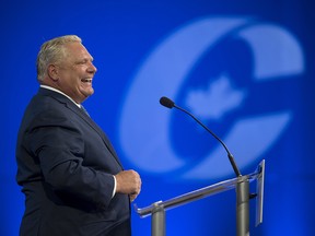 Ontario Premier Doug Ford laughs while speaking at the Conservative national convention in Halifax on Thursday, August 23, 2018.
