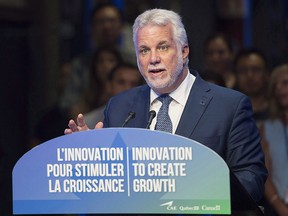 Quebec Premier Philippe Couillard speaks during an investment announcement at CAE Inc. in Montreal on Aug. 8, 2018.
