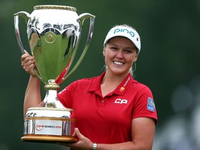 Brooke Henderson lifts the champion's trophy at the CP Women's Open in Regina on Aug. 26.