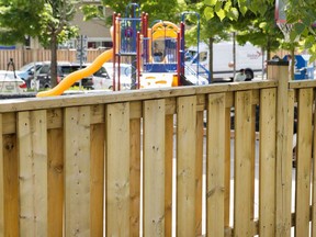 Police mark bullet holes in a fence where two young girls were shot at a playground in Scarborough, Ont., on Friday, June 15, 2018. Toronto police say a second arrest has been made in connection with a daylight shooting that wounded two young sisters in a community playground in the city's east end. There was no immediate word on charges or the suspect's identity.