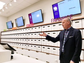 Nova Scotia Liquor Corporation president and CEO Bret Mitchell gestures during a media tour of a cannabis section at one of it's stores in Halifax on Wednesday, July 18, 2018. A Halifax psychology professor is accusing the Nova Scotia Liquor Corporation of "glamourizing and normalizing" cannabis in a way that violates federal regulations, as the Crown corporation defends its signage as educational and informative.