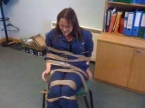 DeeAnn Fitzpatrick is seen, in an undated handout image, during an alleged incident where her coworkers taped her to a chair for complaining about harassment in the office. The family of a Newfoundland-born woman who alleges she suffered a decade of harassment at her civil service office in Scotland say they are disappointed that an employment tribunal has ruled against her claim.