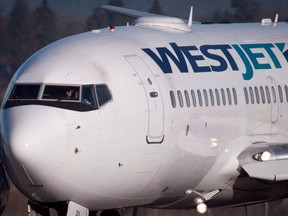 A pilot taxis a Westjet Boeing 737-700 plane to a gate after arriving at Vancouver International Airport in Richmond, B.C., on Monday, February 3, 2014. WestJet today is offering its guests more convenience with the launch of the first ever artificial intelligence (AI) powered chatbot from a Canadian airline.
