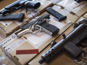 Police display guns seized during a series of raids at a press conference in Toronto on Friday, June 14, 2013. Federal NDP Leader Jagmeet Singh is formally asking the prime minister to immediately give cities the leeway to ban handguns.