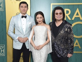 Henry Golding, from left, Constance Wu and executive producer/author Kevin Kwon arrive at the premiere of "Crazy Rich Asians" at the TCL Chinese Theatre on Tuesday, Aug. 7, 2018, in Los Angeles. The first time "Crazy Rich Asians" author Kevin Kwan realized the magnitude of his lavish Singapore-set story, he was in Canada.