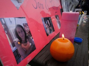 Lit candles and photographs are seen on display at a vigil for Calgary homicide victims Sara Baillie and her five-year-old daughter Taliyah Marsman, in Calgary, on July 17, 2016. A man accused of killing a Calgary woman and her five-year-old daughter was sent to hospital prior to a court appearance Friday. Edward Downey, 48, has entered not guilty pleas to two counts of first-degree murder in the deaths of Sara Baillie and her daughter Taliyah Marsman in 2016.
