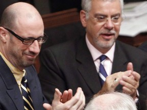 Francois Ouimet, left, looks on during the provincial budget on Tuesday, March 30, 2010 at the legislature in Quebec City. A longtime Quebec Liberal backbencher is being shown the door by the party a week before the provincial election campaign officially begins. The Liberals are looking to reserve the stronghold riding of Marquette for a different candidate and have asked Francois Ouimet to step aside after 24 years.THE CANADIAN PRESS/POOL/Mathieu Belanger