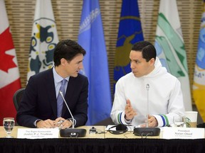 Prime Minister Justin Trudeau talk with Natan Obed, president of the Inuit Tapiriit Kanatami as they participate in the Inuit-Crown Partnership Committee Leaders Meeting in Ottawa on March 29, 2018. Canada's national Inuit organization has re-elected Natan Obed as its leader. The vote was taken today in Inuvik, Northwest Territories. It's Obed's second term at the helm of Inuit Tapiriit Kanatami, which represents 60,000 Inuit people across Canada.