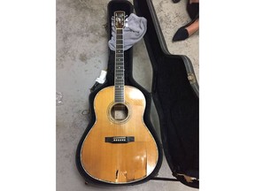 A 1978 Larrivee guitar owned by Remi Claude Arsenault is shown following being damaged by an Air Canada fork lift in this recent handout photo. It's a one-of-a-kind guitar, an instrument so beloved musician Remi Claude Arsenault calls it his "best friend." But the handmade Larrivee met its match with an airport forklift that left gaping stab wounds in the body of the vintage 1978 guitar. Arsenault said Friday he was on his way home from the Milwaukee Irish Fest, where he was performing with Natalie MacMaster, Donnell Leahy and family, when the irreparable damage occurred.