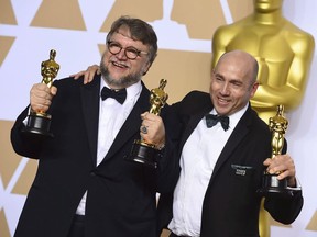 Guillermo del Toro, left, winner of the awards for best director for "The Shape of Water" and best picture for "The Shape of Water", and J. Miles Dale, winner of the award for best picture for "The Shape of Water", pose in the press room at the Oscars on March 4, 2018, at the Dolby Theatre in Los Angeles.