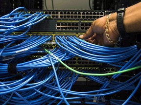 Canada's telecom regulator says the average household spent nearly $223 every month on communications services, including mobile phones, landlines, Internet and cable TV in 2016. Networking cables in a server bay are shown in Toronto on Wednesday, November 8, 2017.