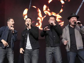98 Degrees band members, from left, Jeff Timmons, Drew Lachey, Nick Lachey and Justin Jeffre perform at KTUphoria 2018 at Jones Beach Theater in Wantagh, N.Y., on June 16, 2018. Reunited boy band 98 Degrees will serenade the masses as part of the upcoming iHeartRadio MMVAs. The heart-throb foursome, known for their late 1990s hits "I Do (Cherish You)" and "Because of You," are among the latest batch of performers announced for the broadcast on Aug. 26.