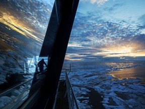 Nigel Greenwood, assistant ice navigator, looks out at the ice from the bridge while standing watch overnight aboard the Finnish icebreaker MSV Nordica as it traverses the Northwest Passage in the Canadian Arctic Archipelago on July 21, 2017.