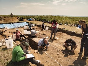 Students from across North America work at a burial site at Rochefort Point at the Fortress of Louisbourg, N.S., in this undated handout photo. A group of student archaeologists spent the summer working against the clock to excavate human remains from an 18th century Nova Scotia burial site before they get washed into the sea.