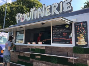 Owners Masha Klimova and Alexey Kolesov's "Poutinerie" food truck is being prepared for the day at the Faces & Laces Festival in Gorky Park, Moscow, Russia, Saturday August 18, 2018.