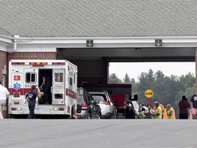 Emergency personnel work at the scene of an auto auction crash that left several people injured, Wednesday, Aug. 1, 2018, at Southern Auto Auction in East Windsor, a suburb of Hartford. A man lost control of a car at an auto auction after apparently suffering a medical emergency behind the wheel Wednesday and crashed into other vehicles and pedestrians, leaving multiple people injured, police said.