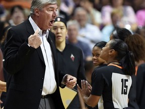 FILE - In this Sunday, Aug. 5, 2018, file photo, Las Vegas Aces head coach Bill Laimbeer, left, offers his opinion on a call to official Fatou Cissoko-Stevens during the first half of WNBA basketball game action against the Connecticut Sun in Uncasville, Conn. The WNBA has ruled that Las Vegas will forfeit its game against Washington that was canceled Friday night, Aug. 4, 20018,  when the Aces players decided not to play because of concerns about their health and safety after 26 hours of travel.