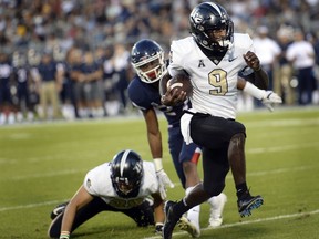 Central Florida running back Adrian Killins Jr. (9) runs the ball in for a touchdown during the first half of an NCAA college football game against Connecticut on Thursday, Aug. 30, 2018, in East Hartford, Conn.