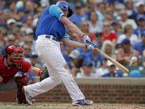 Chicago Cubs' Daniel Murphy hits a two-run home run against the Cincinnati Reds during the second inning of a baseball game Saturday, Aug. 25, 2018, in Chicago.