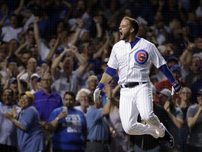 Chicago Cubs' David Bote reacts as he rounds the bases after hitting the game-winning grand slam against the Washington Nationals during the ninth inning of a baseball game Sunday, Aug. 12, 2018, in Chicago. The Cubs won 4-3.