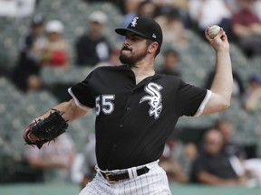 Chicago White Sox starting pitcher Carlos Rodon throws against the Minnesota Twins during the first inning of a baseball game Wednesday, Aug. 22, 2018, in Chicago.