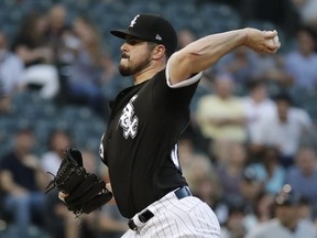 Chicago White Sox starting pitcher Carlos Rodon throws to a Cleveland Indians batter during the first inning of a baseball game Friday, Aug. 10, 2018, in Chicago.