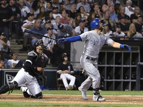 Kansas City Royals' Alex Gordon watches his RBI sacrifice fly against the Chicago White Sox during the third inning of a baseball game Friday, Aug. 17, 2018, in Chicago.