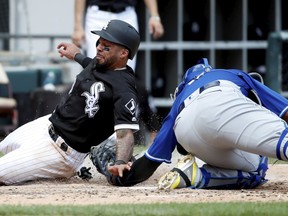 Kansas City Royals catcher Salvador Perez, right, tags out Chicago White Sox's Leury Garcia, left, trying to steal home during the fifth inning of a baseball game in Chicago, on Thursday, Aug. 2, 2018.