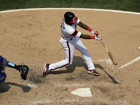 Chicago White Sox's Tim Anderson, right, hits a two-run home run during the fourth inning of a baseball game against the Kansas City Royals, Sunday, Aug. 19, 2018, in Chicago.