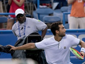 Noah Rubin, of the United States, throws his shoe into the crowd after defeating John Isner, of the United States, 6-4, 7-6 (6) during the Citi Open tennis tournament in Washington, Thursday, Aug. 2, 2018.