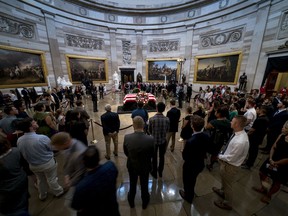 Members of the public pay their respects as Sen. John McCain, R-Ariz., lies in state in the Rotunda of the U.S. Capitol, Friday, Aug. 31, 2018, in Washington.