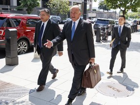 Richard Westling, left, and Thomas Zehnle, center, with the defense team for Paul Manafort, leave federal court in Washington, Tuesday, Aug. 28, 2018, after previewing of cases as they argue over how much jurors will be allowed to hear of the former Trump campaign chairman's lengthy foreign lobbying career.