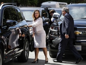 Canada's Foreign Affairs Minister Chrystia Freeland, left, walks to a car during a break in trade talk negotiations from the Office of the United States Trade Representative, Thursday, Aug. 30, 2018, in Washington. At right is David MacNaughton, Canada's Ambassador to the United States.